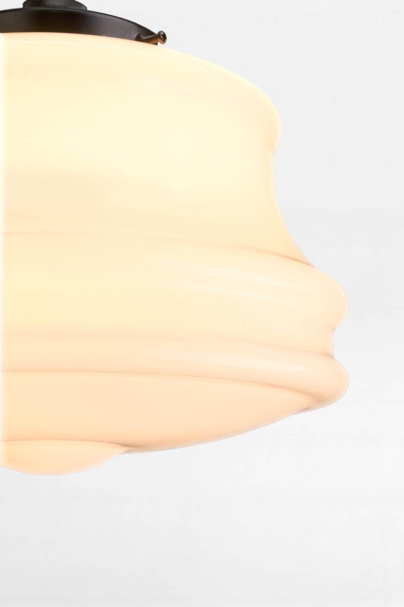 A close-up of shade features graceful tiered curves in handmade opal glass 