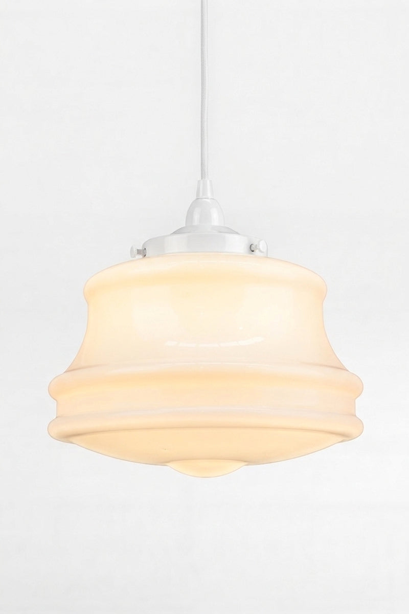 Opal glass schoolhouse style shade with white pendant cord. 
