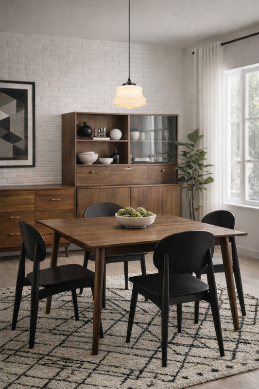 Schoolhose style opal glass shade on a black pendant cord over a light dining room with timber furnishing. 