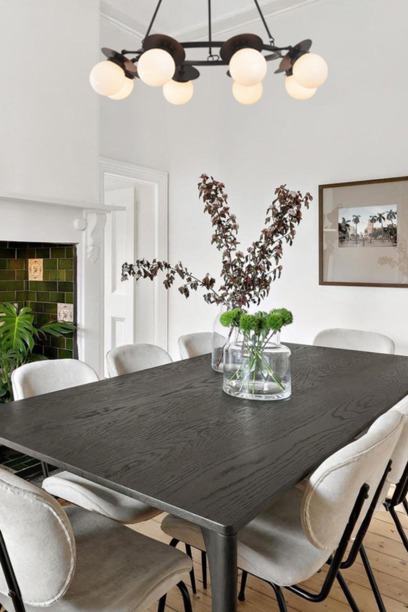 Dining room with a large ceiling light chandelier wooden table, chairs