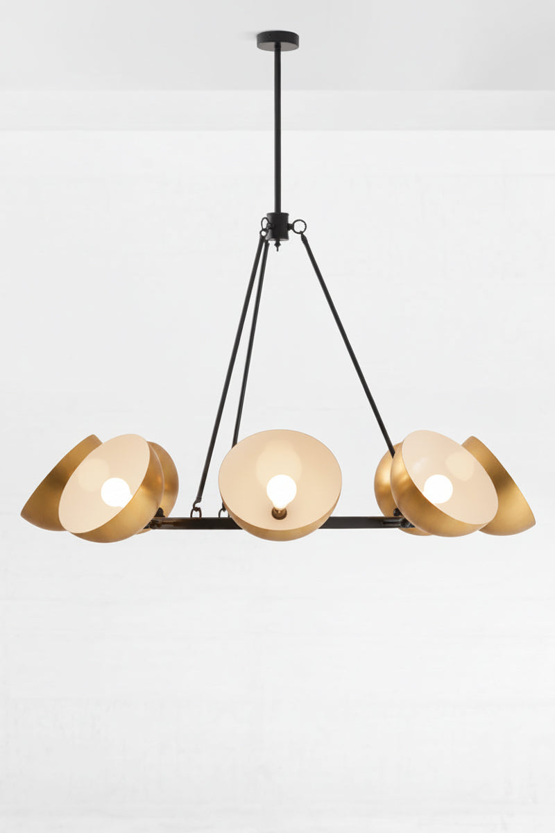 Gold brass shades, eight of them on chandelier shades facing up and out. 