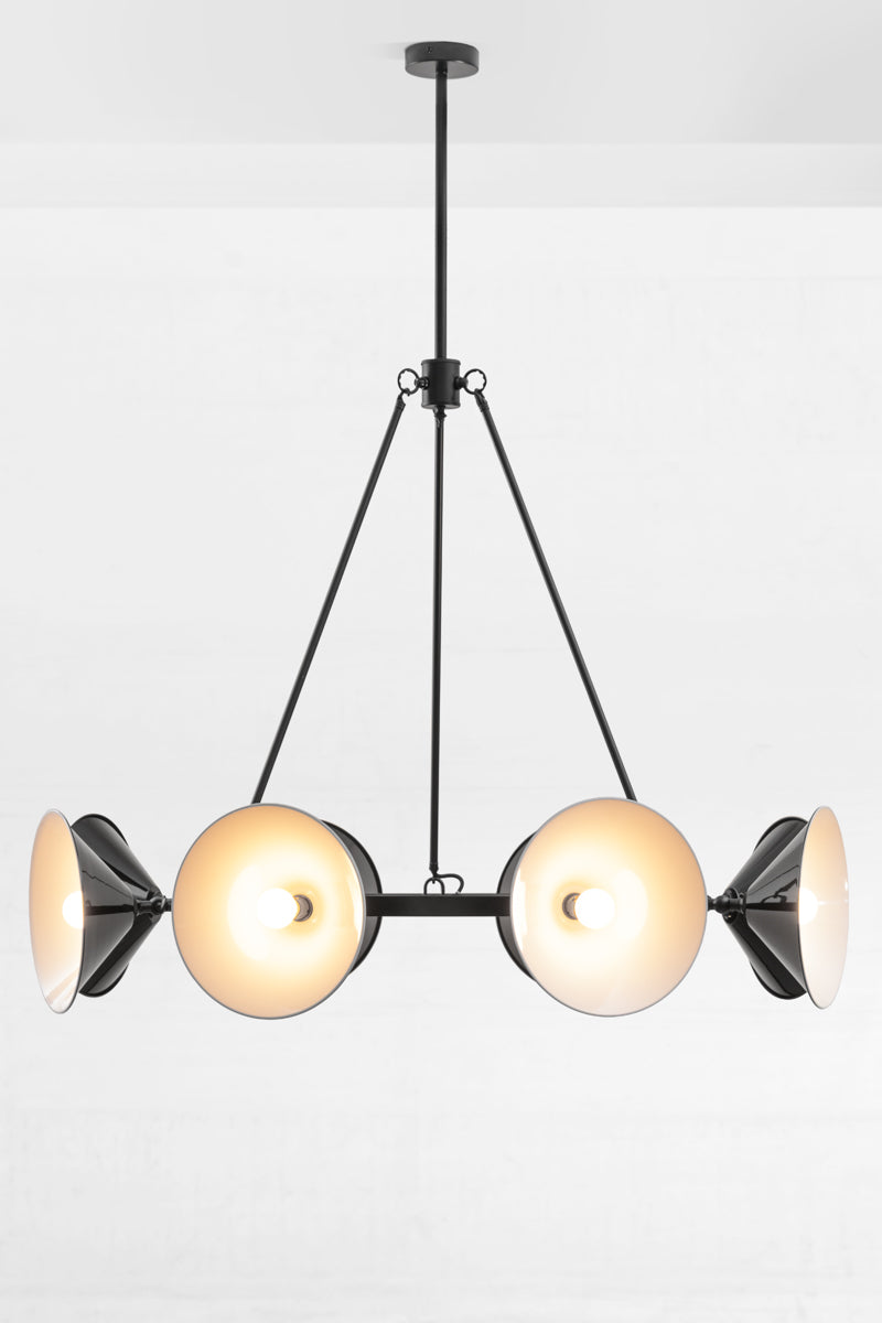 Eight cone shades in black facing out on the adjustable lampholder of the black, circular chandelier.