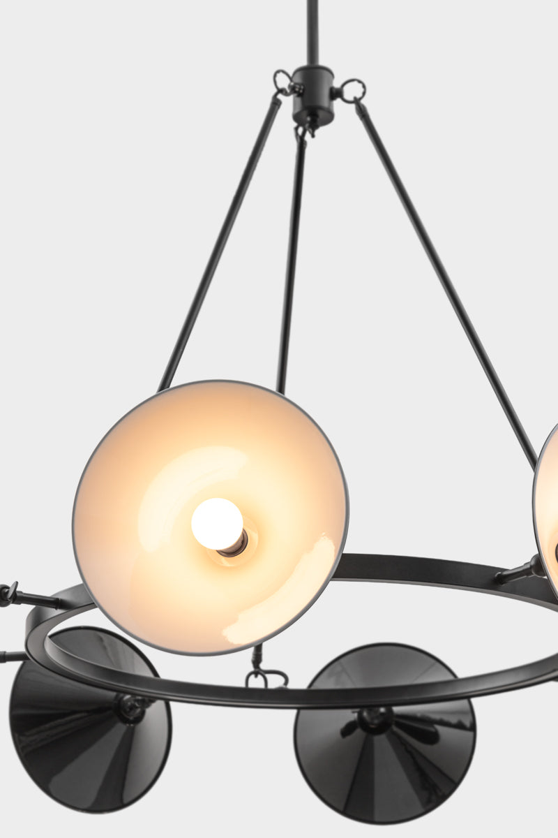 Close up of the Eight light black, circular chandelier with black cone shades, showing white inner. 
