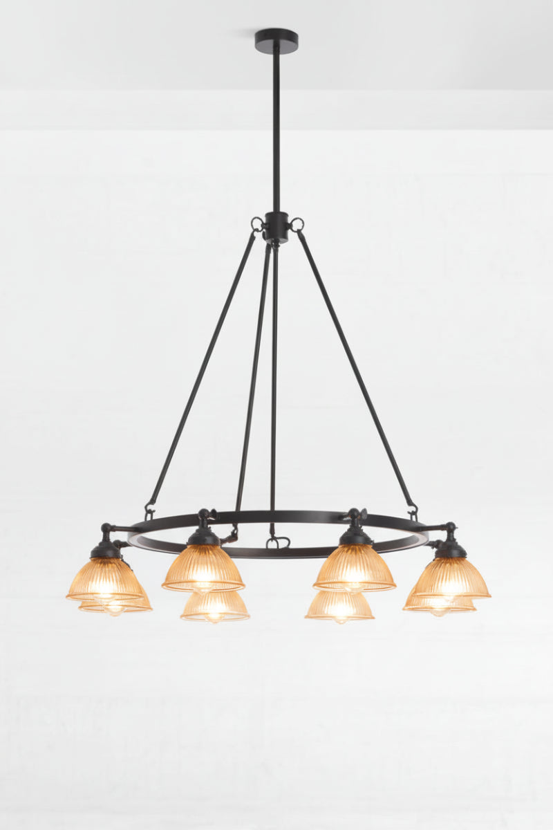 8 amber reeded glass shades on a black circular chandelier