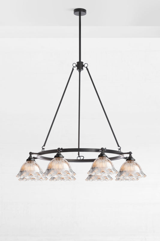 Clear ribbed glass shades on an 8 light black circular chandelier. 