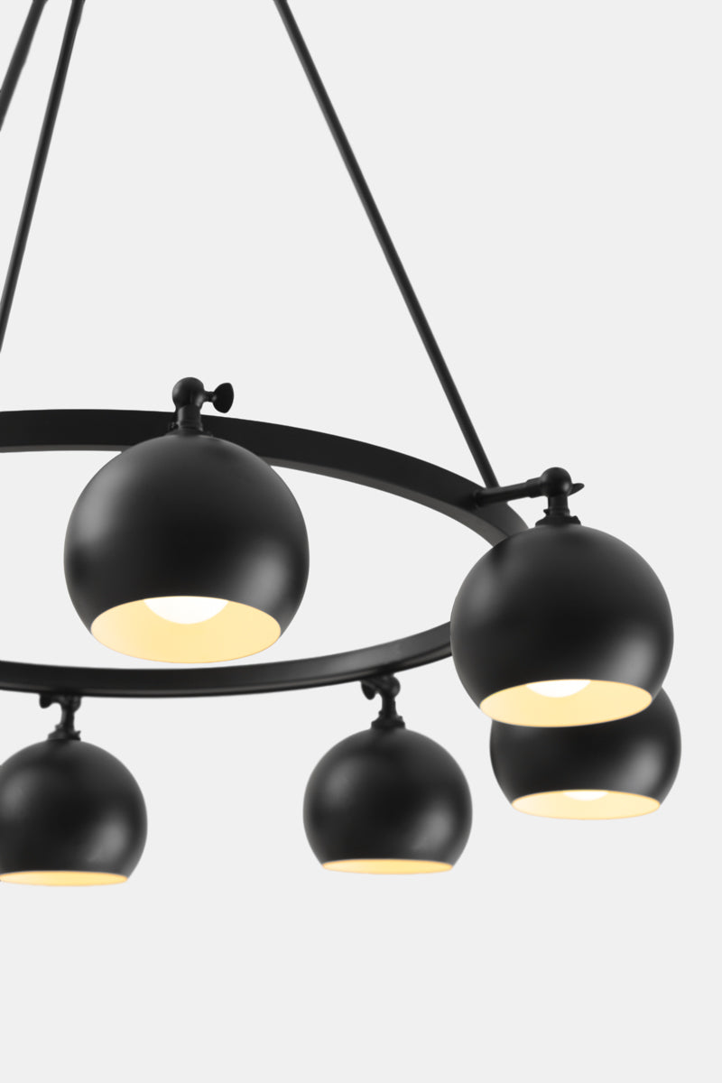Close up of the 8 light bulb shade circular chandelier in black, with lampholders facing down.
