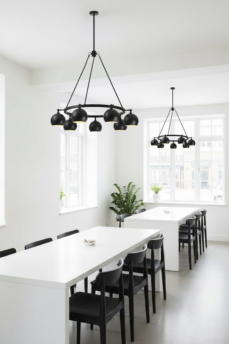 8 light bulb shade circular chandelier in black, with lampholders facing out over a lunch room break out setting in an office.