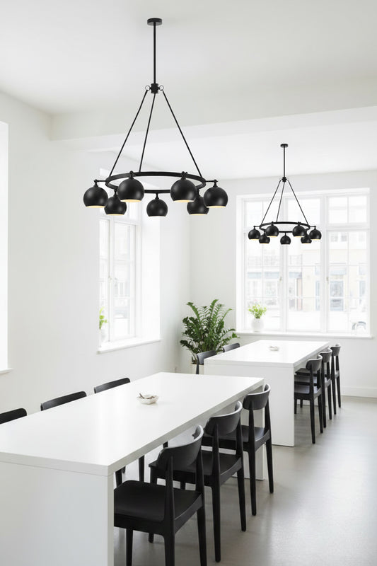 8 light bulb shade circular chandelier in black, with lampholders facing out over a lunch room break out setting in an office.