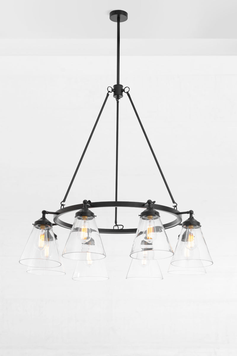 Black 8 light cirlcular chandelier with large clear glass cone shades facing downward. 