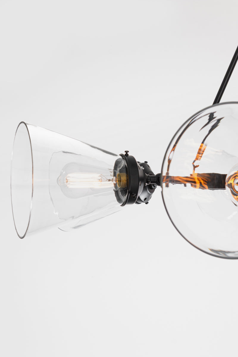 Close up of the large clear glass shade, along with 2 1/4 inck black galleries and clear tear drop shades. 