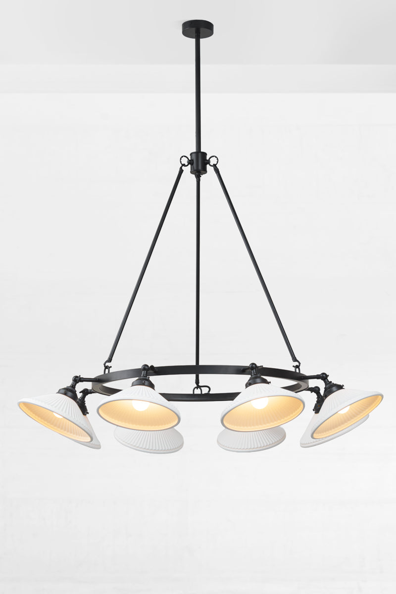 Black 8 light circular chandelier with white ceramic shades facing  down. 