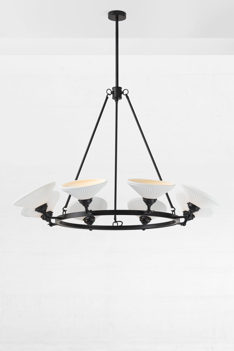 Black 8 light circular chandelier with white ceramic shades facing up. 