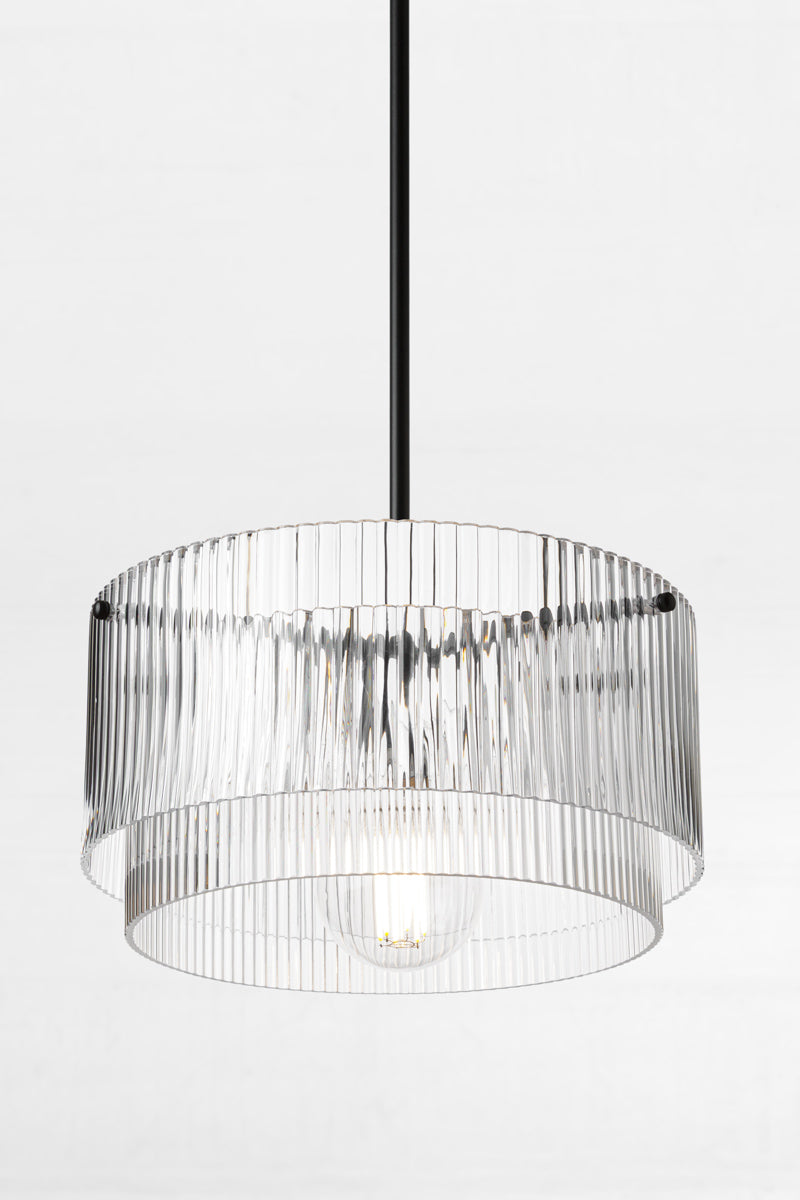 Two tiered clear glass shades with fluted detailing paired with a black pole pendant suspension and a clear round bulb. 