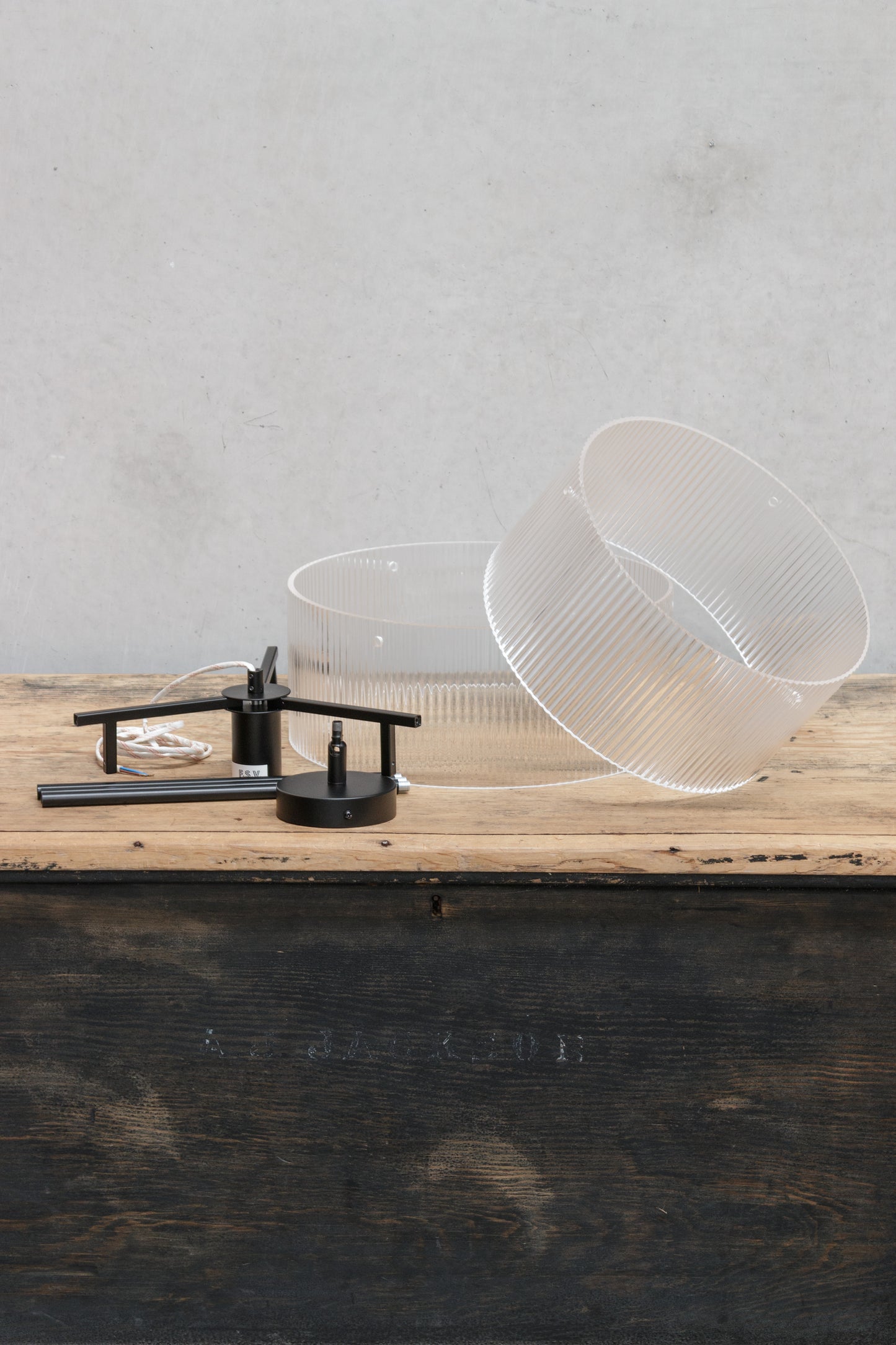 Uninstalled two tiered clear glass shades with fluted detailing paired with a black pole pendant suspension and tiltable ceiling rose. 