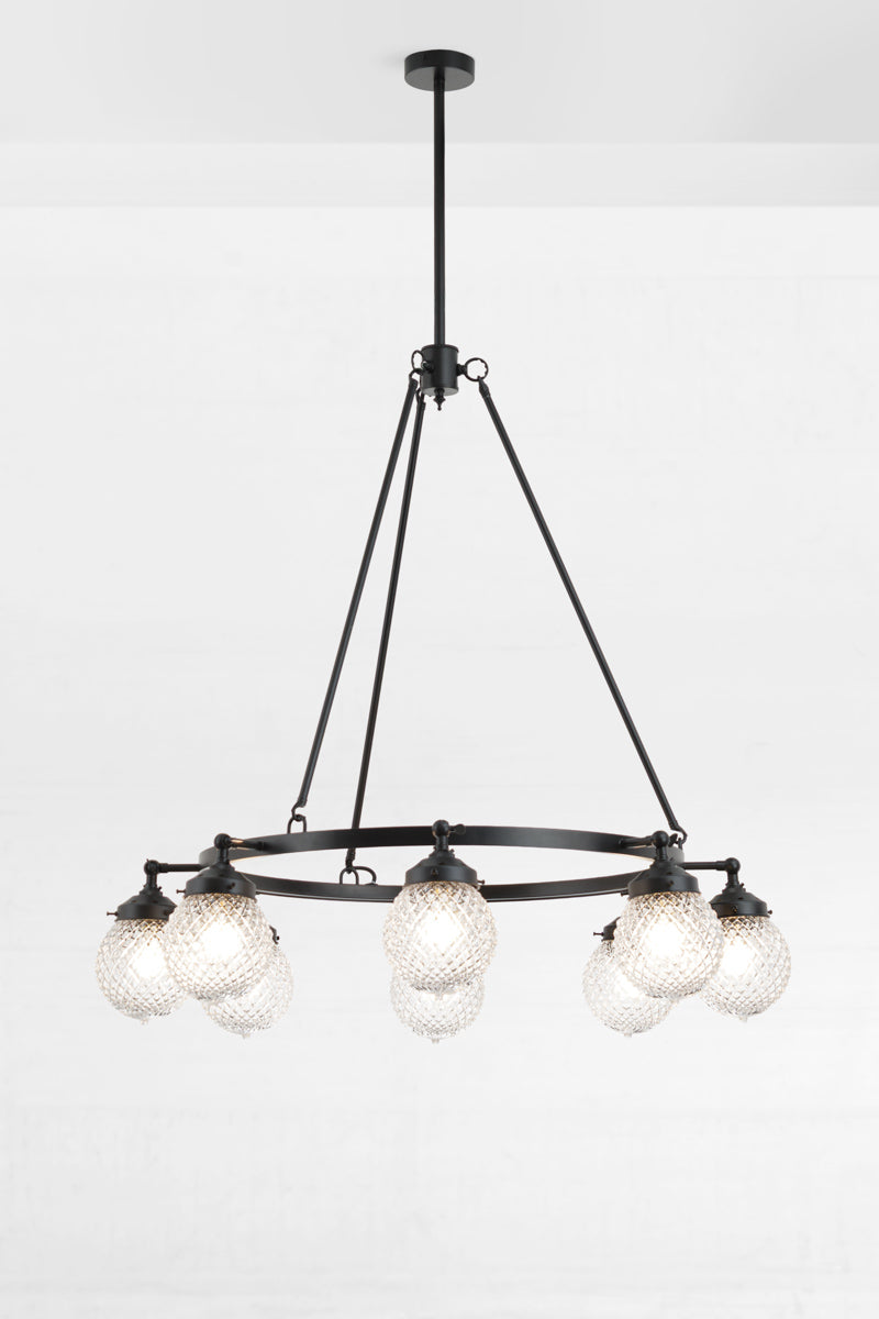 Black circular 8 light chandelier with clear glass orb shades with a vintage inspired design. 