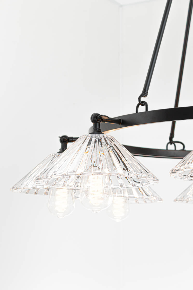 Close up of the clear pleated conical shades facing down. 