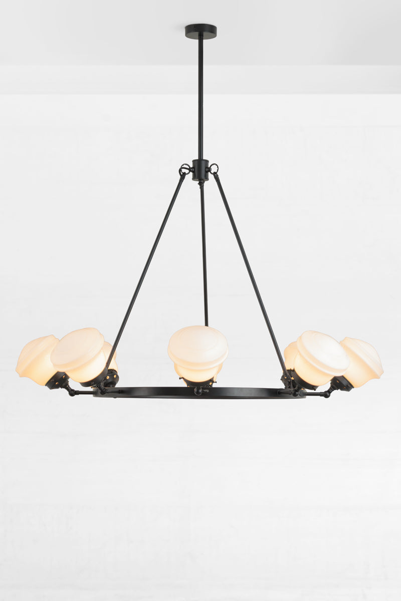 Black circular chandelier with 8 adjustable lampholders, paired with 8 opal schoolhouse style shades. 