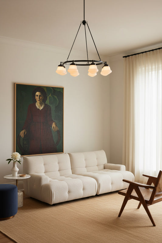8 Light Circular Chandelier. The circular frame supports eight schoolhous shades in a living room