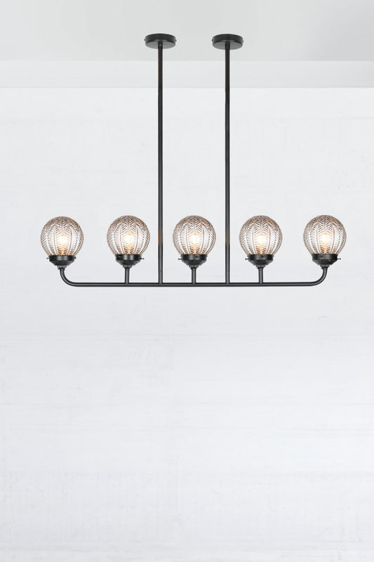 Black 5 light linear chandelier with clear glass ball with vintage designs. 