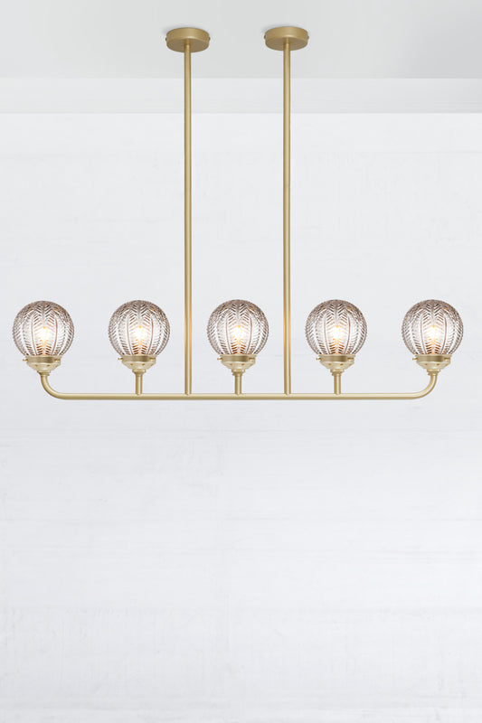 Gold/brass 5 light linear chandelier with clear glass ball with vintage designs. 
