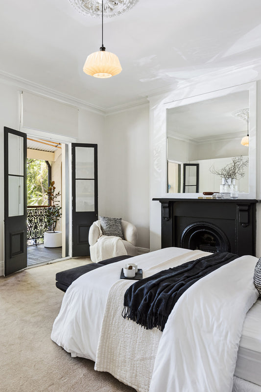 Opal shade with geometric art deco inspire detailing in an updated tradional style bedroom. 