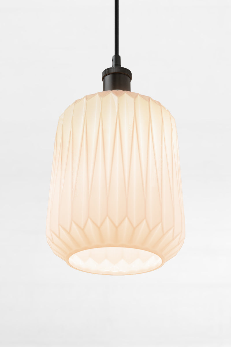 Under view of the opal shade with geometric design on a black pendant cord. 