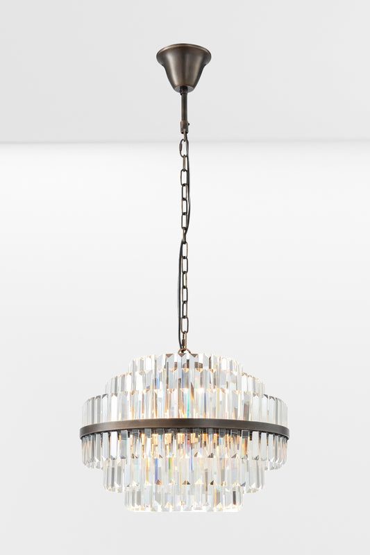Medium glass chandelier with antique brass metalwear and three tiers. 