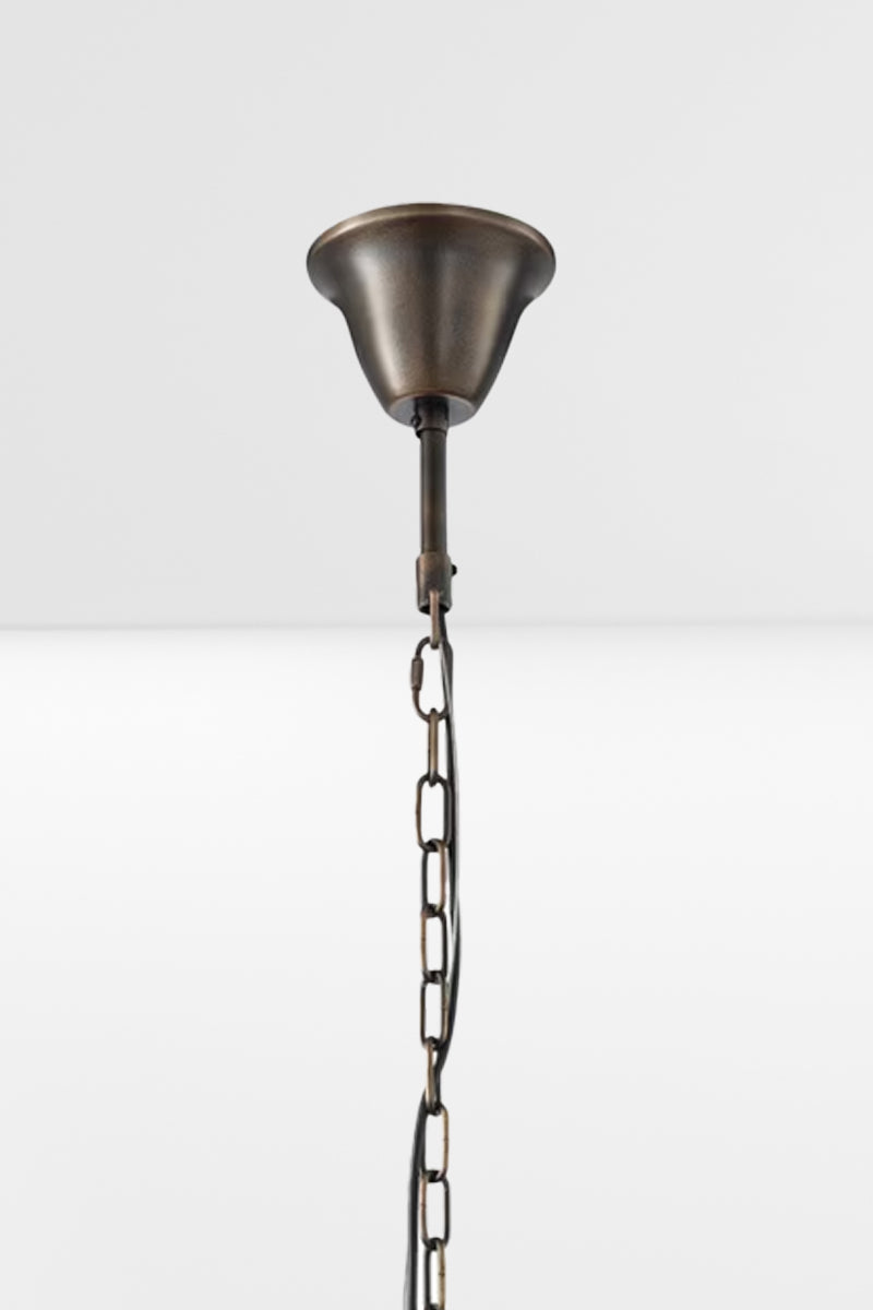 Close up of the antique brass ceiling rose and top of the chain/cord suspension.