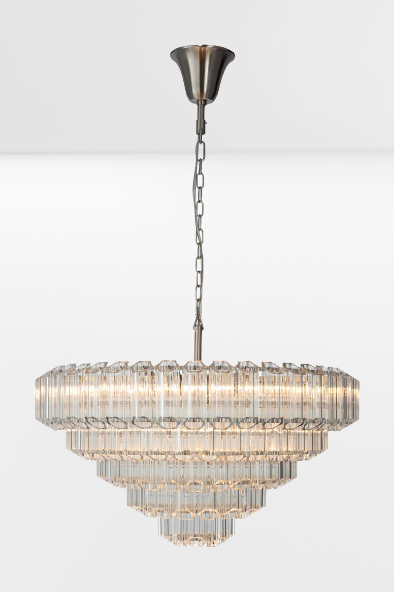 Extra large glass chandelier with chrome finished metalware and five tiers, with lights on. 