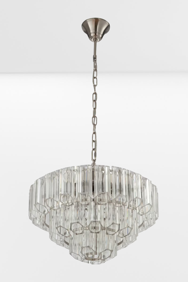 Large glass chandelier with chrome finished metalware and three tiers and lights off.