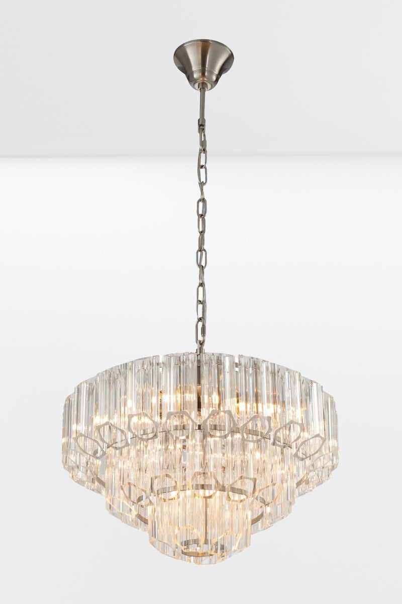 Angled view of the large glass chandelier with chrome finished metalware and three tiers.