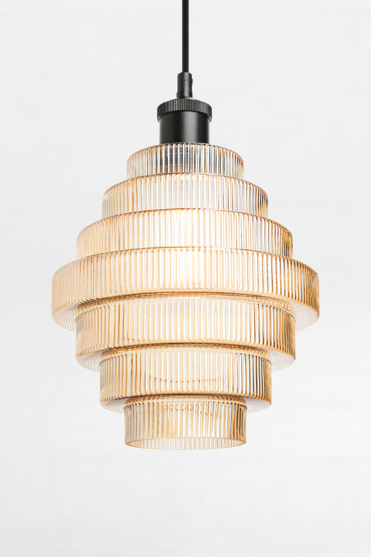 Amber tiered and reeded glass pendant with black lampholder and cord. 