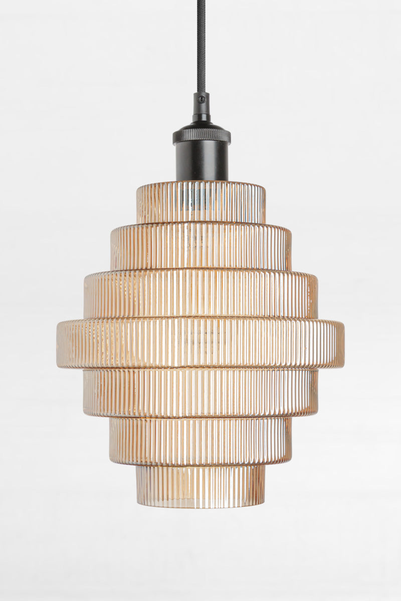 Amber tiered and reeded glass pendant with black lampholder and cord. 