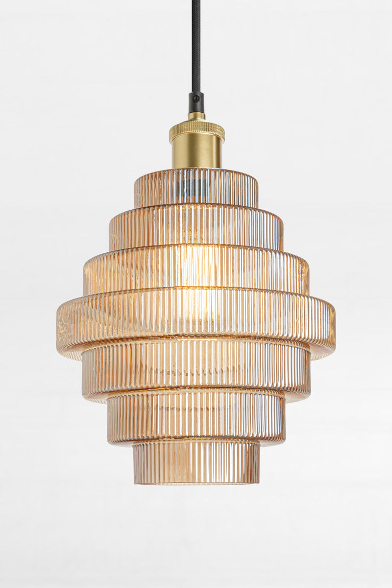 Amber tiered and reeded glass pendant with gold/brass lampholder and cord. 