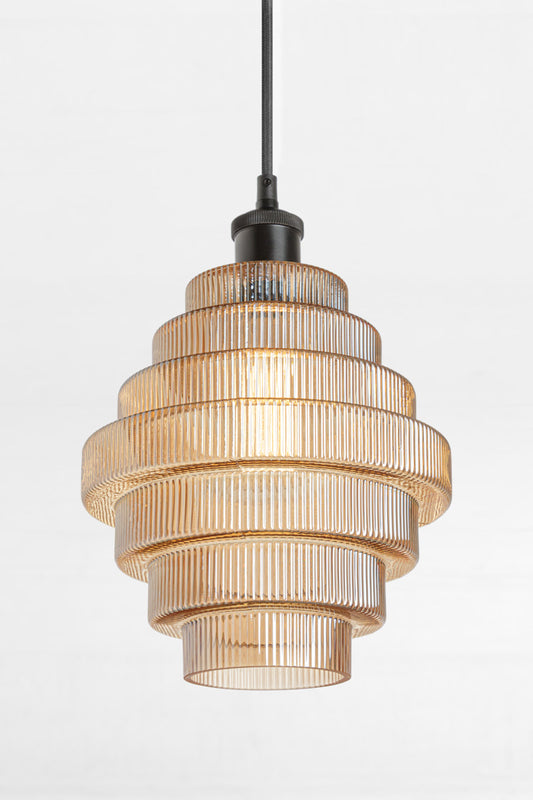 Amber tiered and reeded glass pendant with black lampholder and cord. 