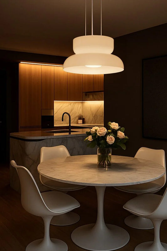 Opal glass shade pendant with an integrated LED light source over a modern dining space 