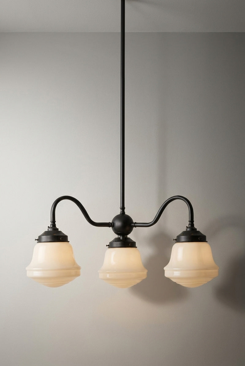 Black three light Colton Schoolhouse Gooseneck Chandelier with curved arms and glowing opal glass shades.