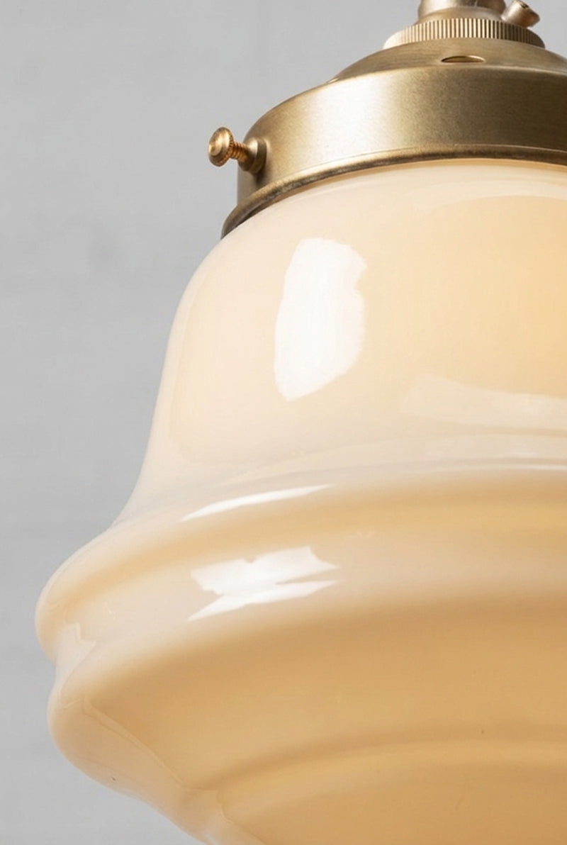 Close-up of the Colton Schoolhouse opal glass shade with gold brass metal gallery and curved detailing.