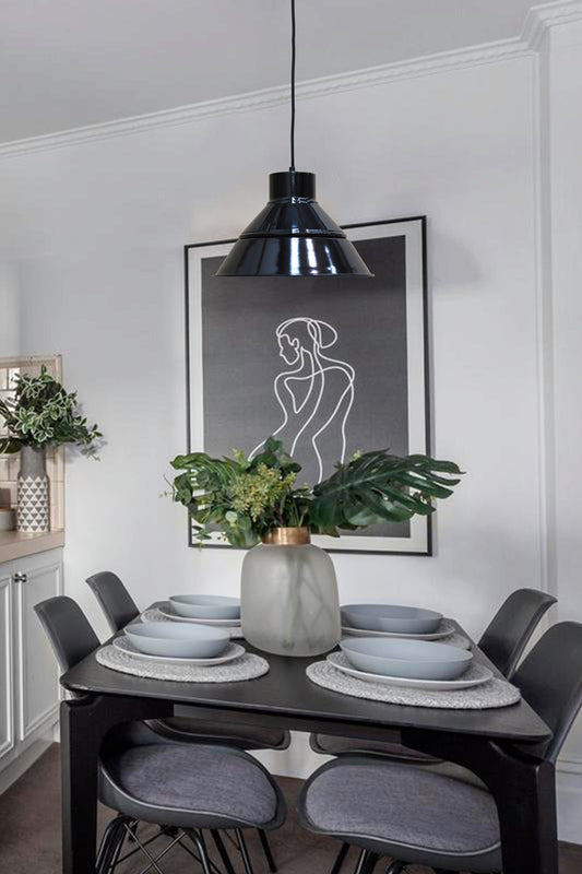 Black shade with black shade cover pendant light of a modern dining space. 