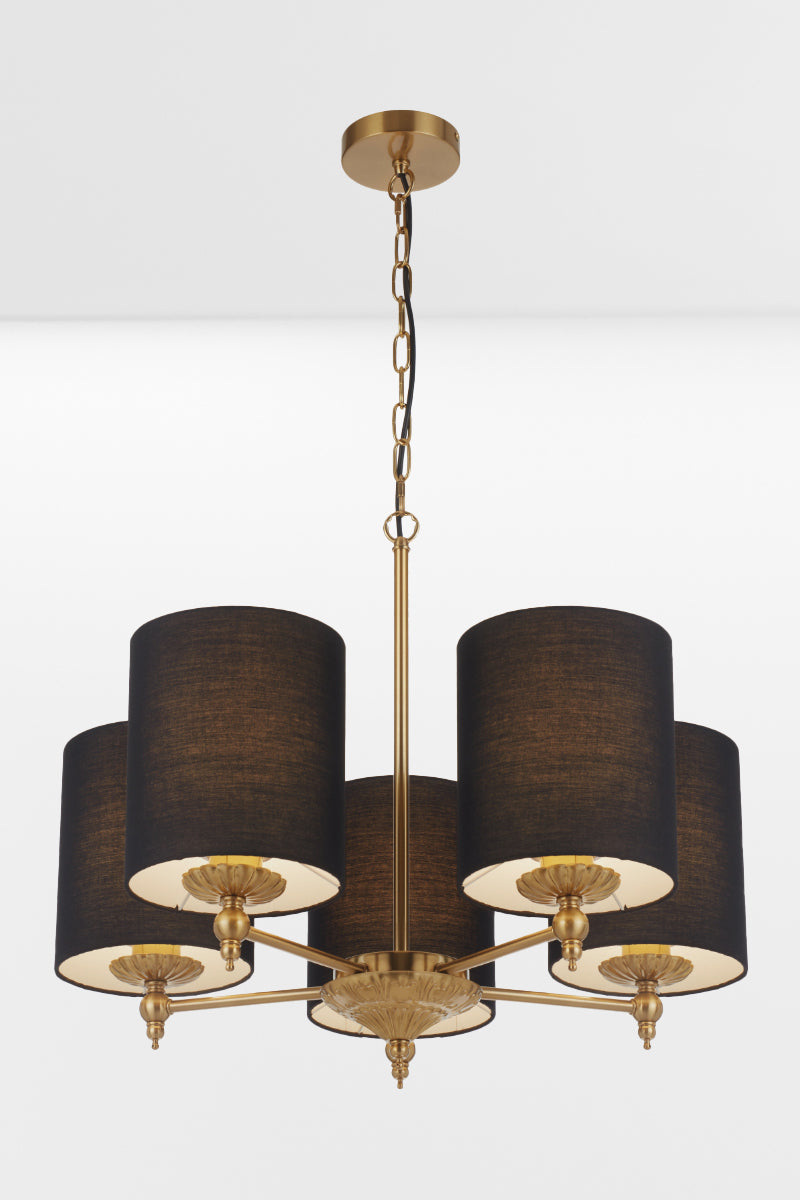Close up of the frame of the 5 light antique gold chandelier with black satin shades with lights on