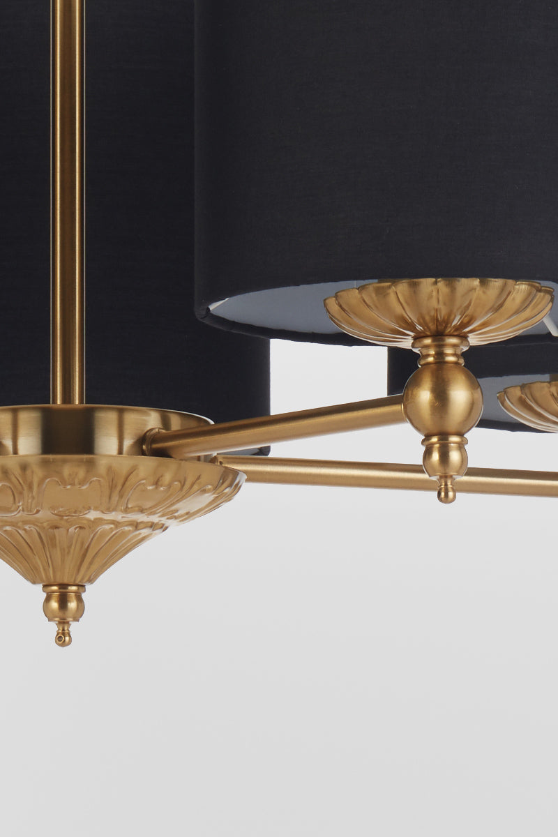 Close up of the frame of the 5 light antique gold chandelier with black satin shades