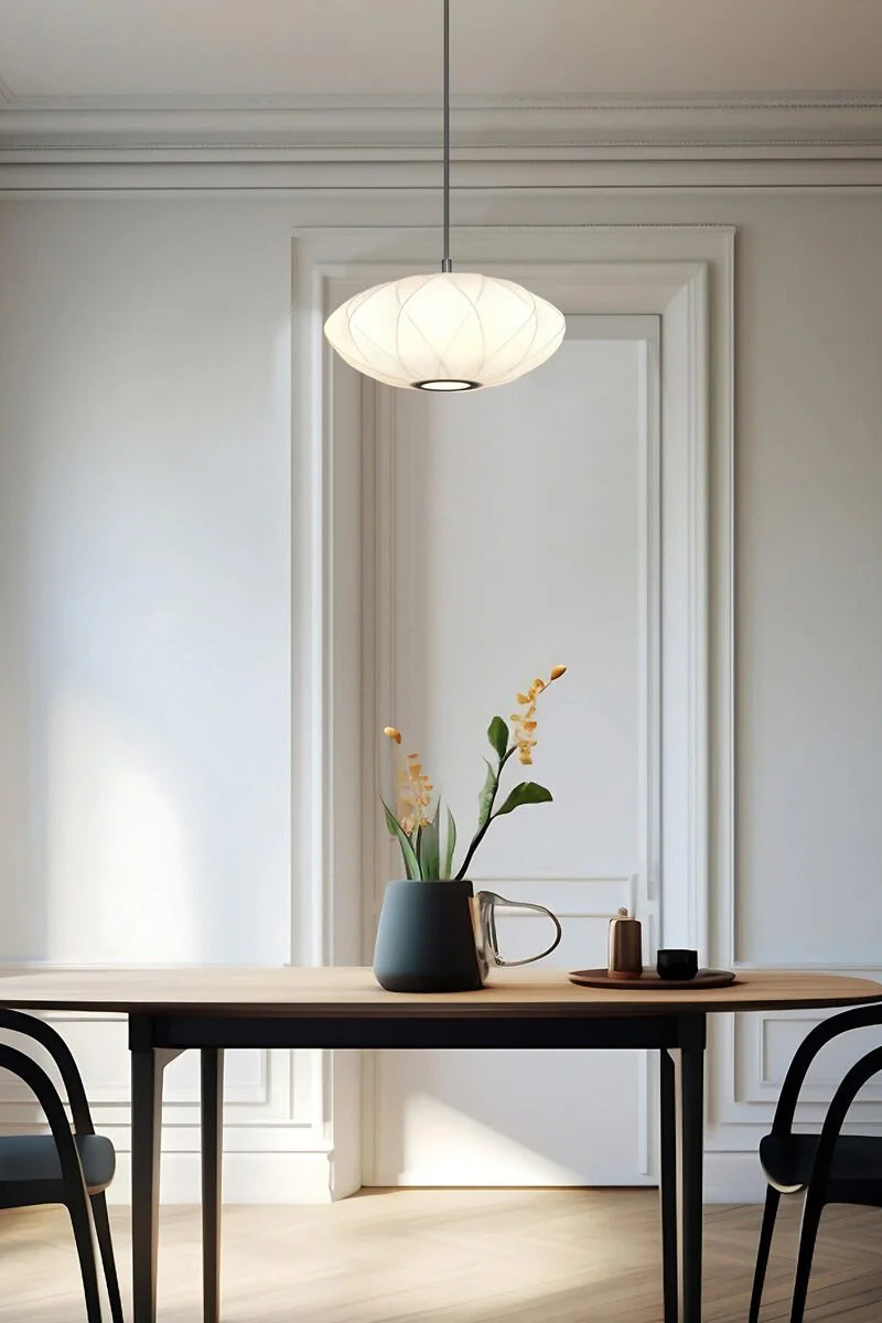 Small whie fabric shade over a dining space. 