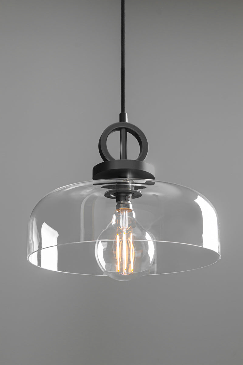 Dixon NYC Glass Pendant Light in matt black featuring a broad clear glass dome, circular metal suspension and exposed decorative filament bulb.