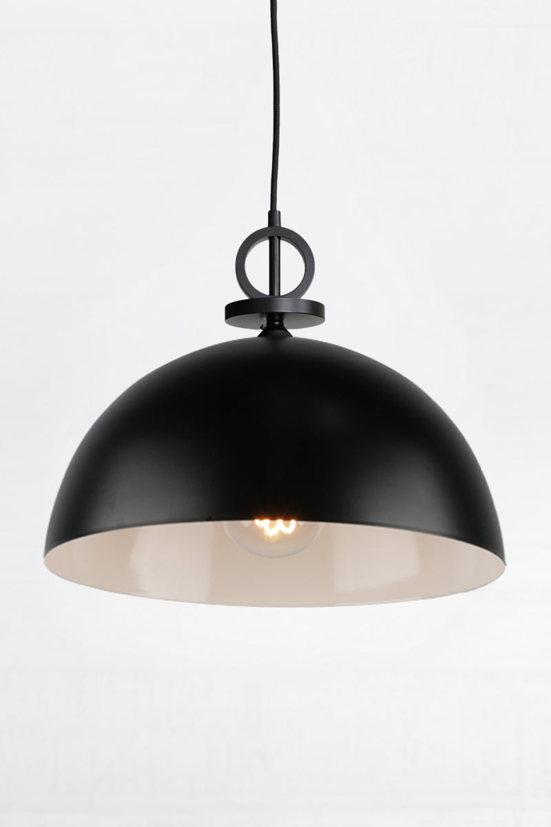 Large black steel dome shade with white inner and black pendant cord with disc detailing. 