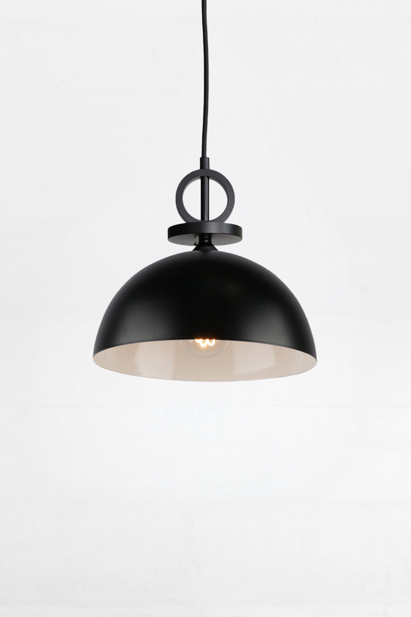 Small black steel dome shade with white inner and black pendant cord with disc detailing. 