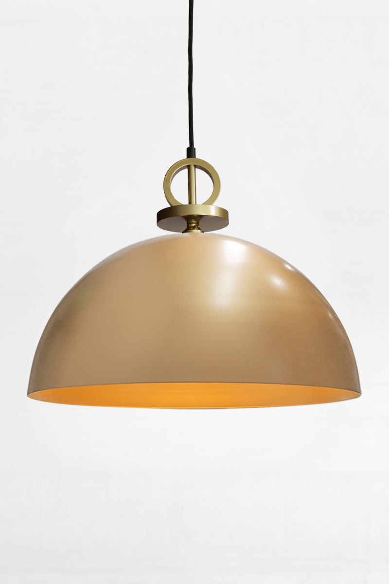 Large gold/brass steel dome shade paired with a black pendant cord with gold/brass disc detailing. 