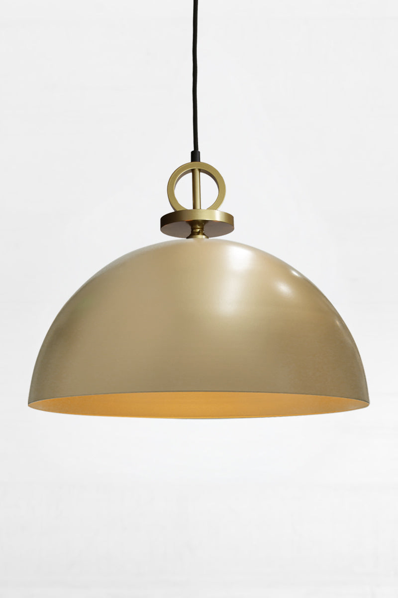 Large gold/brass steel dome shade paired with a black pendant cord with gold/brass disc detailing. 