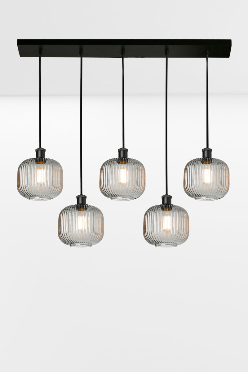 5 light linear multi pendant light with grey reeded open glass shades in a staggared formation. 