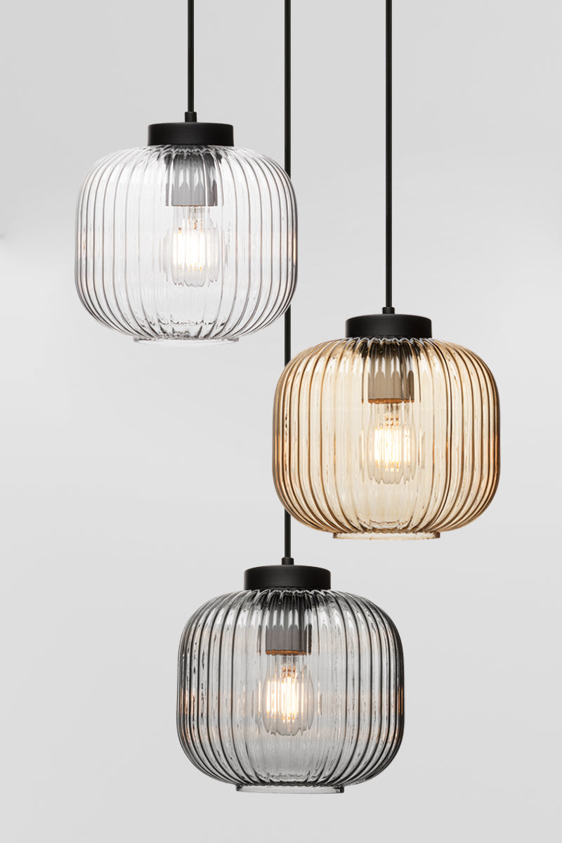 Three drop pendant light with reeded glass shades in clear, amber and grey. 