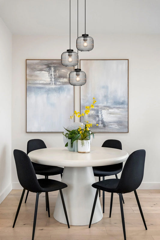 Three grey reeded glass shades on black pendant holders over a modern clean dining space. 
